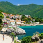 Coastal Promenade View Framed by Mediterranean Foliage